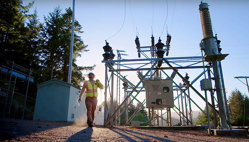 PG&E employee walking in front of electrical equipment