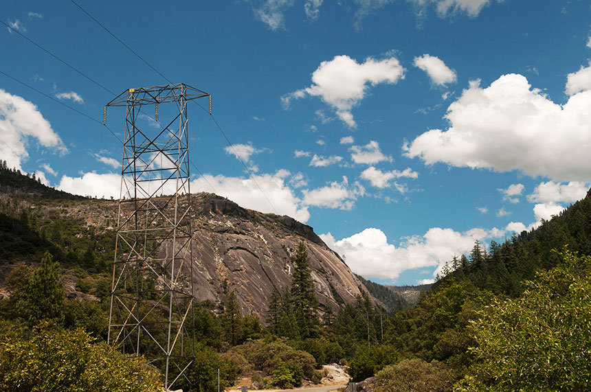 Electric transmission tower with mountain in the background