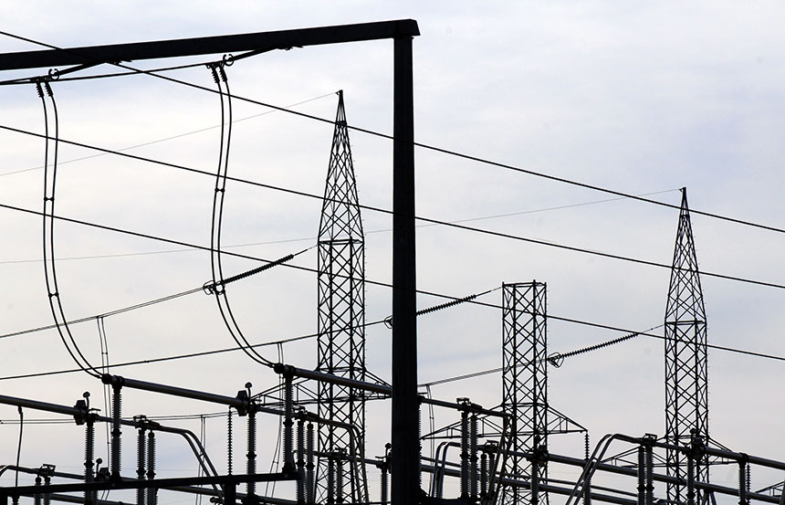 Electric substation towers and cables against the sky