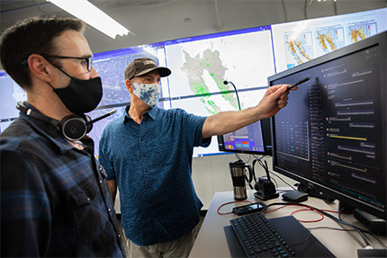 Two coworkers looking at a computer screen