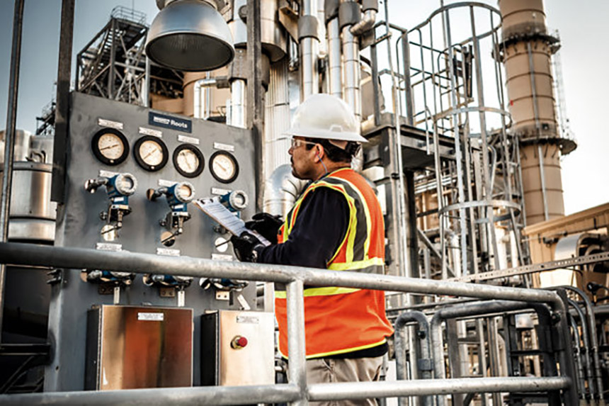 PG&E employee looking at dials on a panel at a power plant
