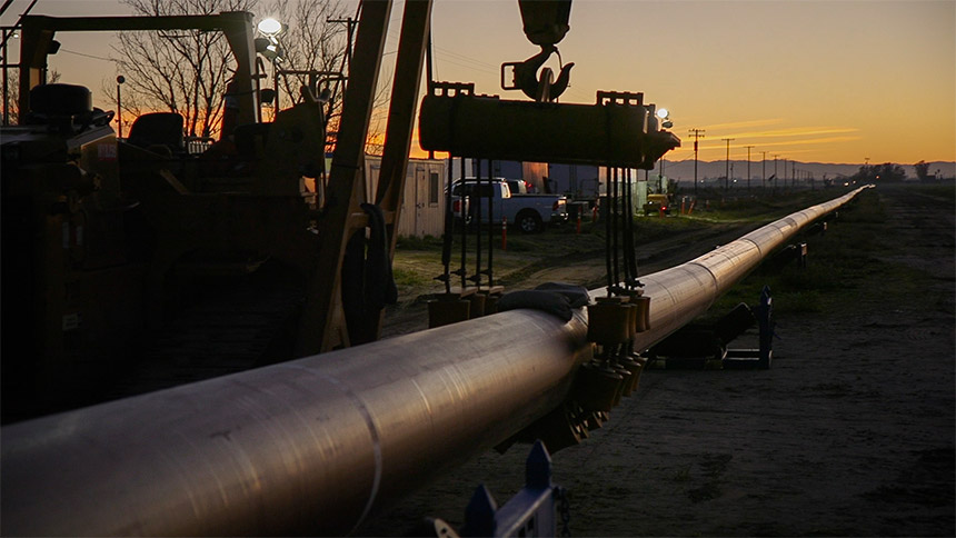 Gas pipeline lying on the ground at sunset