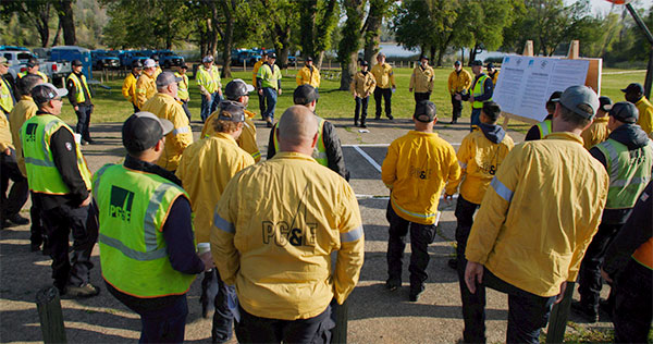 A group of PG&E employees listening to someone speaking